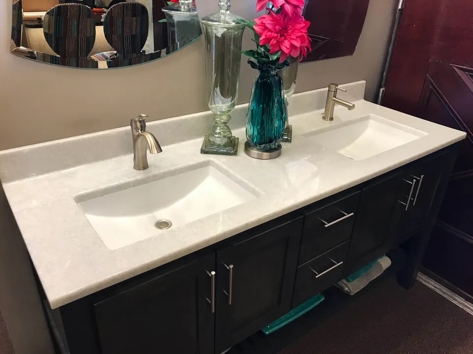 Onyx Collection double vanity top on a dark wood cabinet (manufacturer photo)